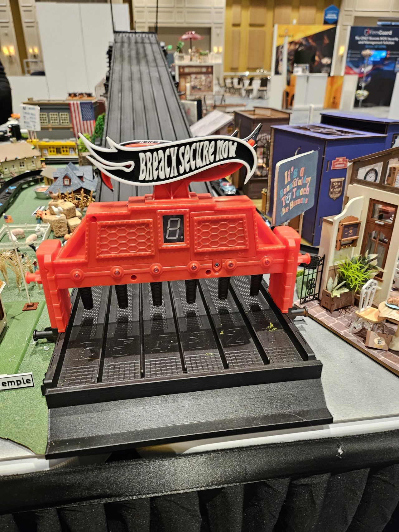 The racetrack starting gate at the City of BSN booth, IT Nation Connect 2025, topped with a red Breach Secure Now flag