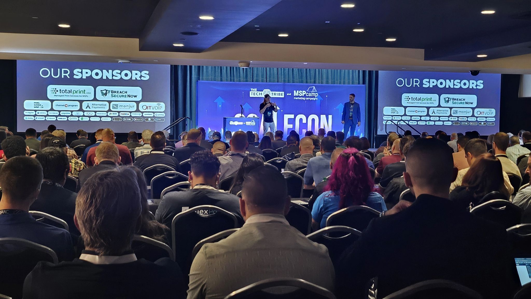 The ballroom stage at ScaleCon24 in Las Vegas, with sponsor screens either side